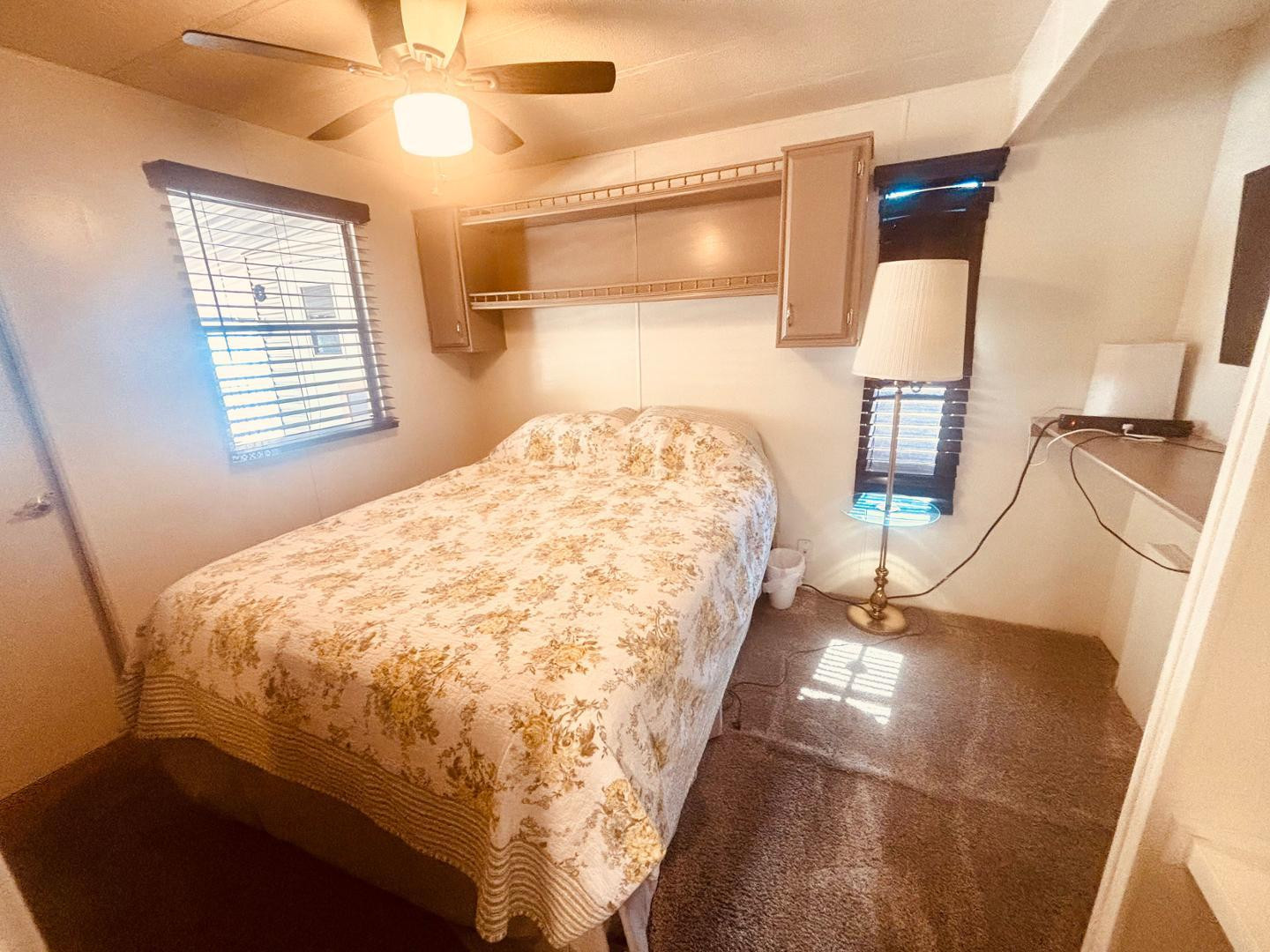 8865 East Baseline Road, Unit 405 Mesa, AZ 85209 - Photo 9 of 16 a bed sitting in a bedroom next to a window