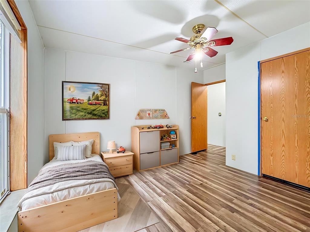 1819 Sinclair Hills Road Lutz, FL 33549 - Photo 40 of 60 a bedroom with a bed and a chandelier