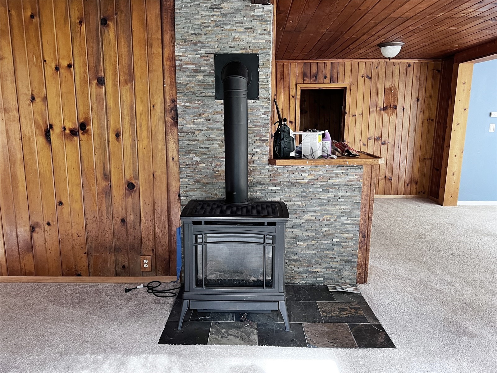 6889 Sills Road Clinton, WA 98236 - Photo 8 of 34 a view of a livingroom with wooden floor and a fireplace