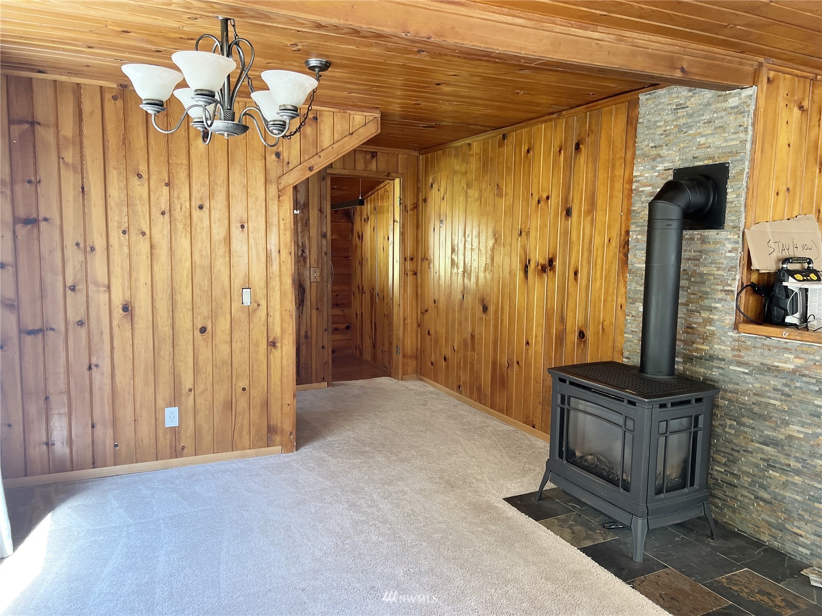 6889 Sills Road Clinton, WA 98236 - Photo 9 of 34 a view of a hallway with a chandelier