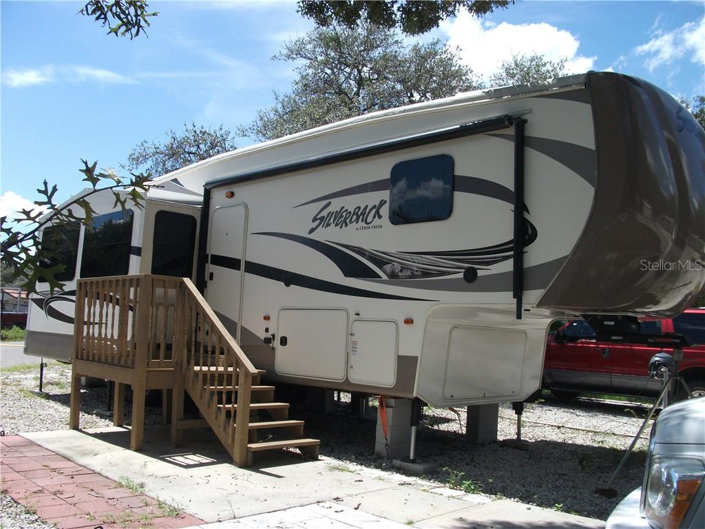 a view of a balcony with wooden floor and outdoor seating