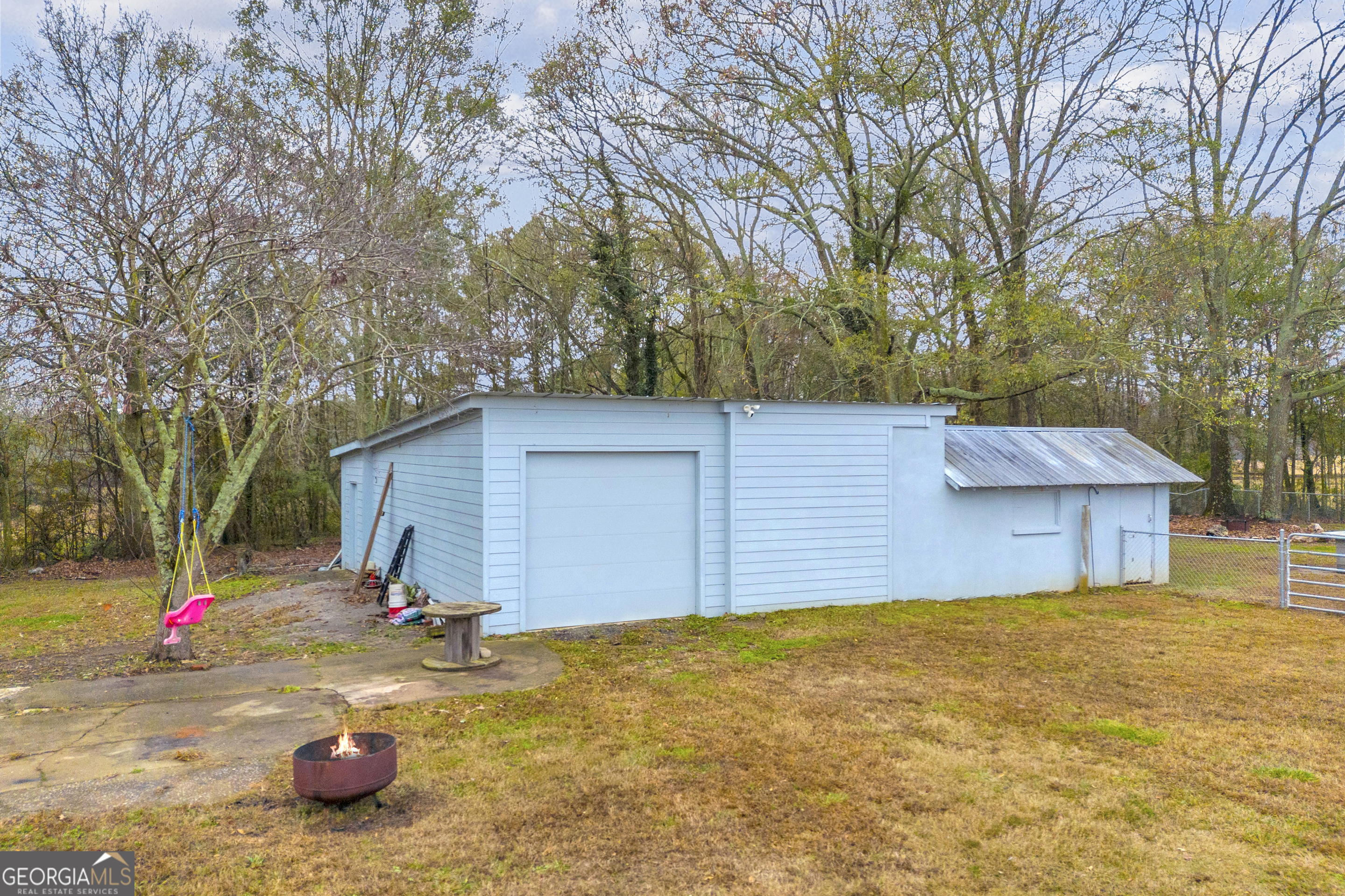 975 Diamond Hill Neese Road Colbert, GA 30628 - Photo 37 of 59 a view of backyard of house with slide and trees