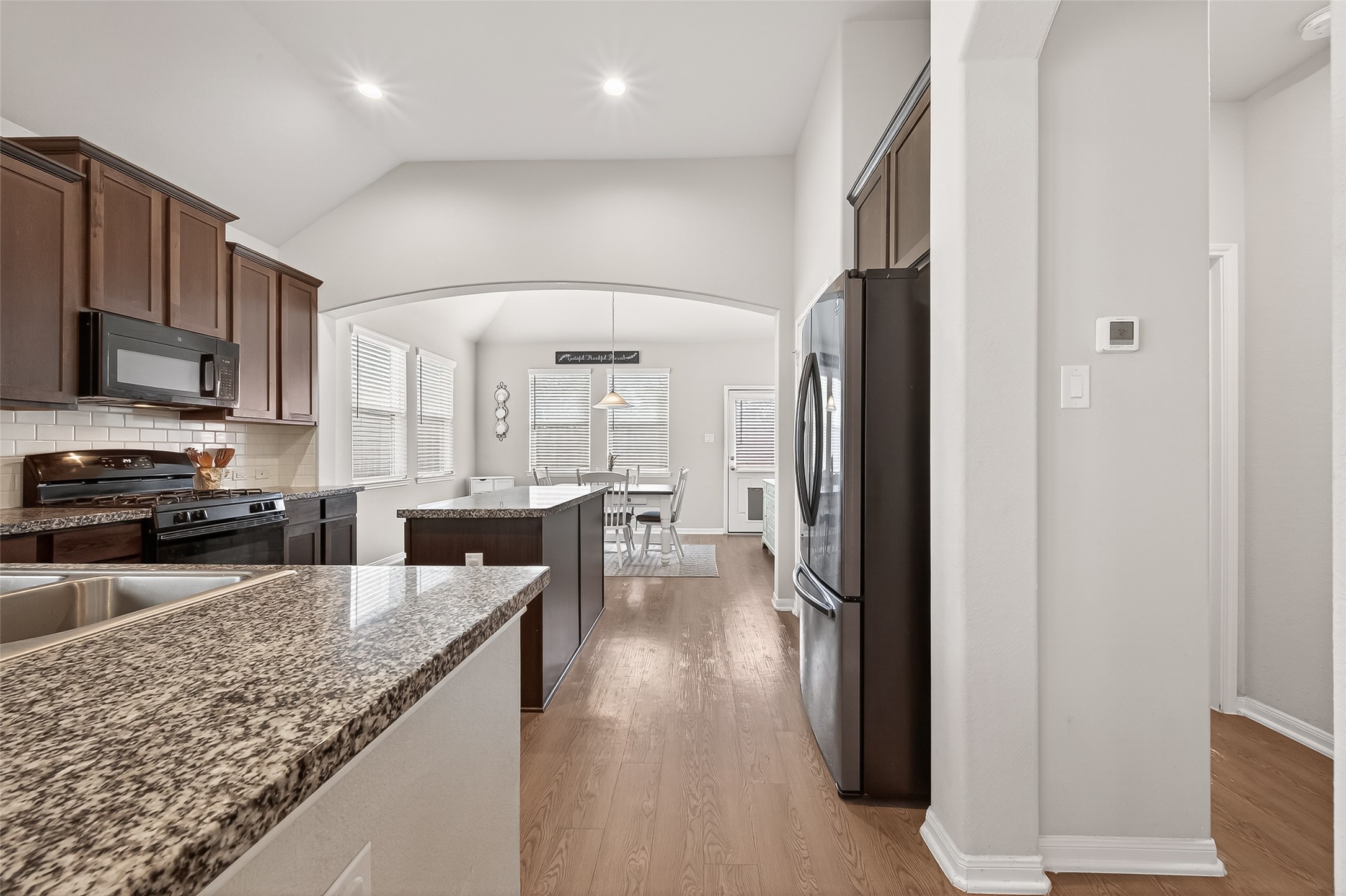 6027 Prince Place Drive Rosenberg, TX 77471 - Photo 23 of 39 a kitchen with a refrigerator a sink and cabinets