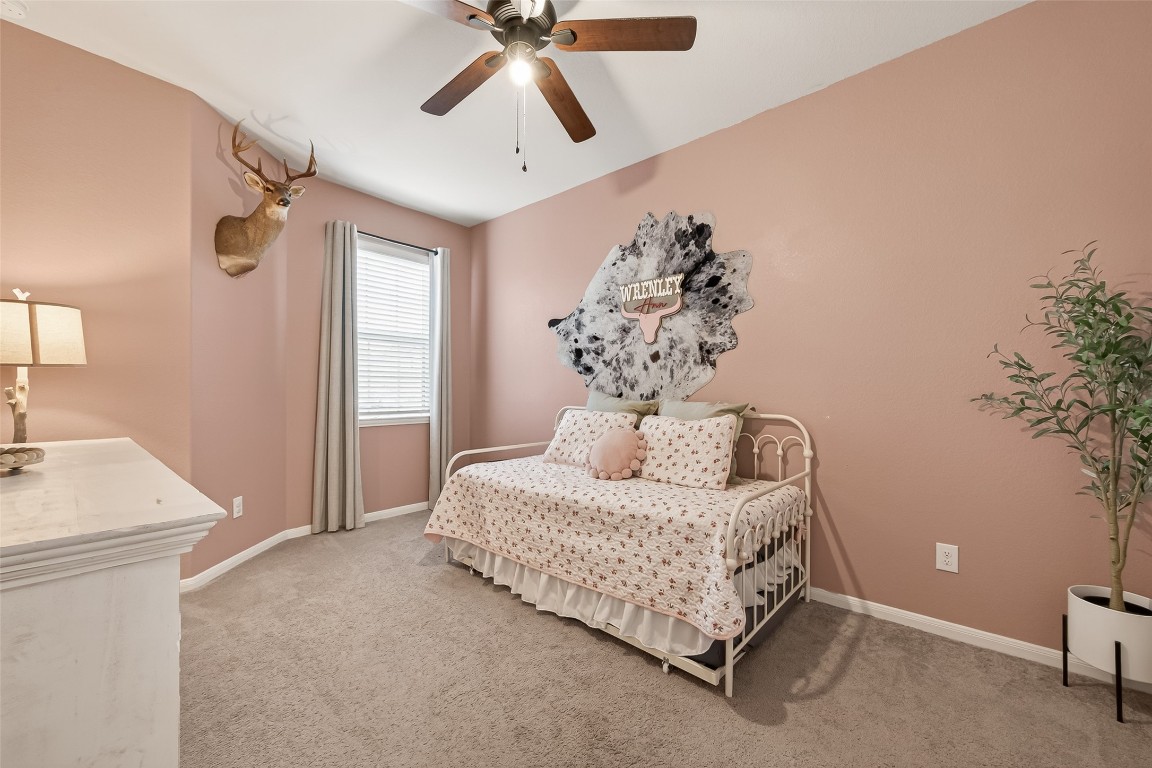 6027 Prince Place Drive Rosenberg, TX 77471 - Photo 26 of 39 A cozy secondary bedroom with a calming palette—perfect for guests or a quiet place to get some work done.