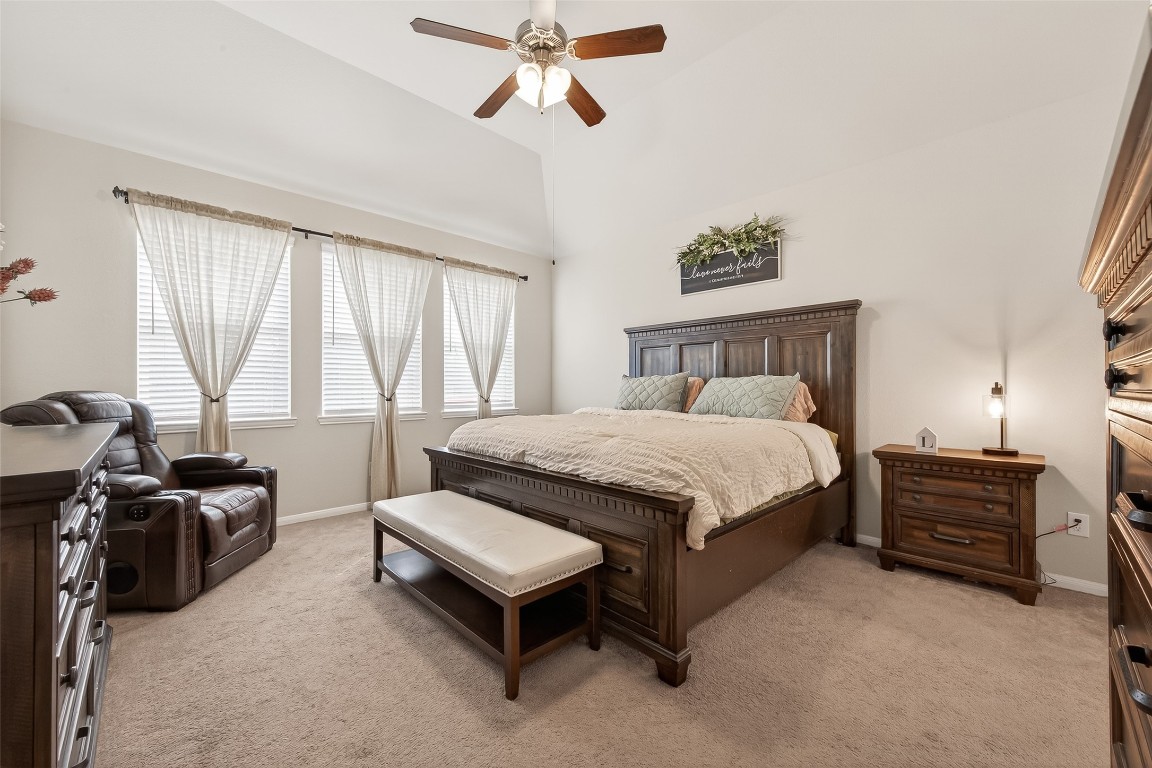 6027 Prince Place Drive Rosenberg, TX 77471 - Photo 30 of 39 Featuring an en suite bath through double doors, the primary suite feels like a private wing with its high ceilings and a wall of windows bringing daylight in.
