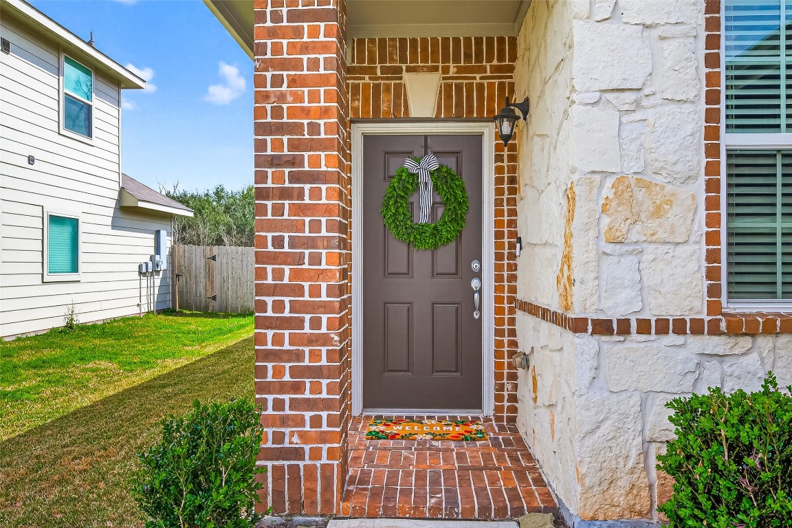 6027 Prince Place Drive Rosenberg, TX 77471 - Photo 3 of 39 The covered entry is set back from the garage front—a nice, private spot to step out of the rain or sun before heading inside.