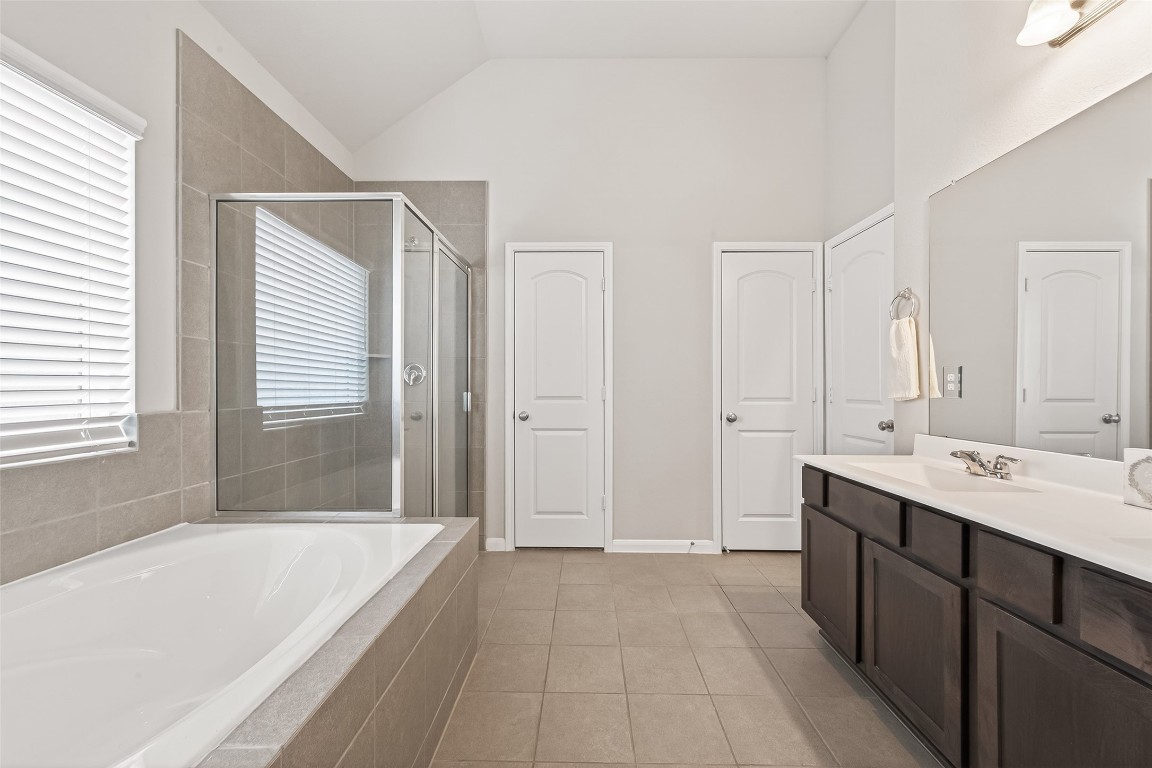 6027 Prince Place Drive Rosenberg, TX 77471 - Photo 34 of 39 You’ve got options in this en suite—a deep tub right under a wide window for a long soak, or a separate glass-enclosed shower for when you’re on the go.
