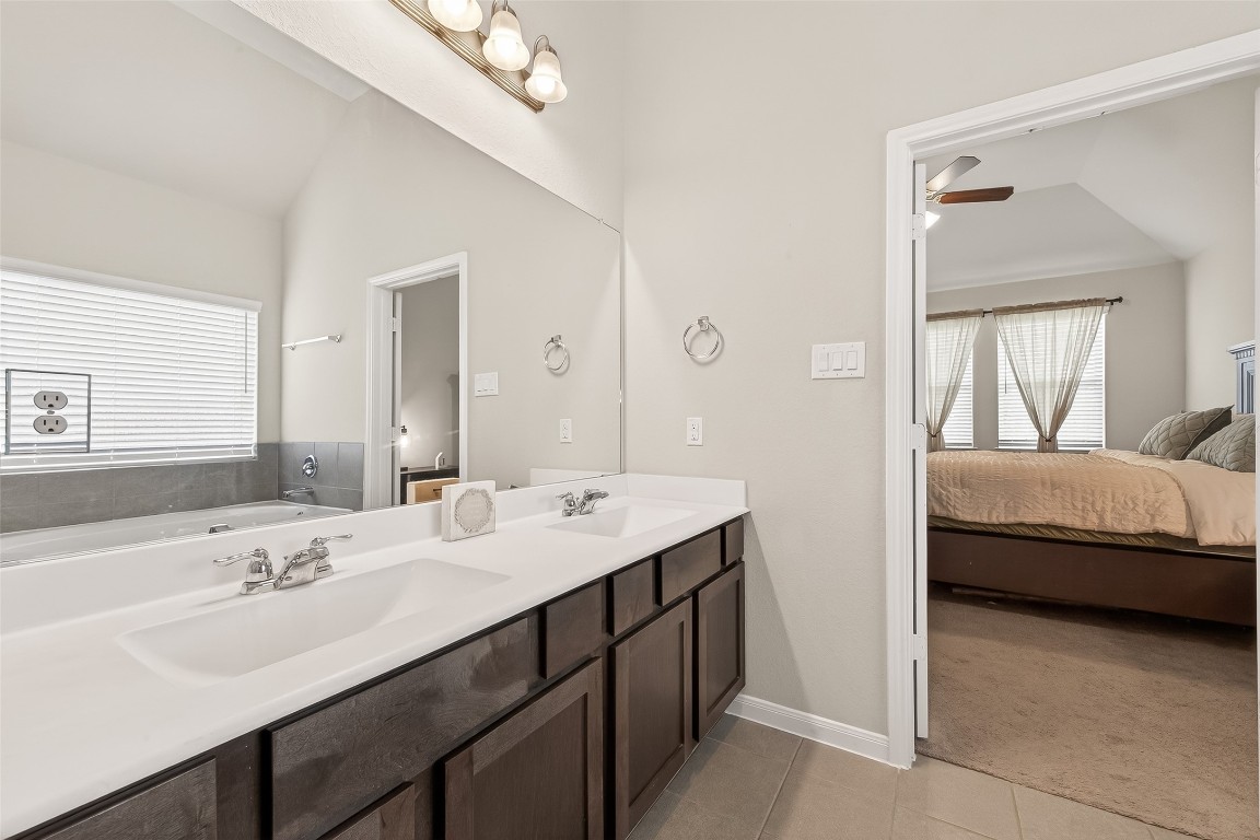 6027 Prince Place Drive Rosenberg, TX 77471 - Photo 37 of 39 No more bumping elbows in the morning; the primary bath features a massive dual-sink vanity and a huge mirror to match.