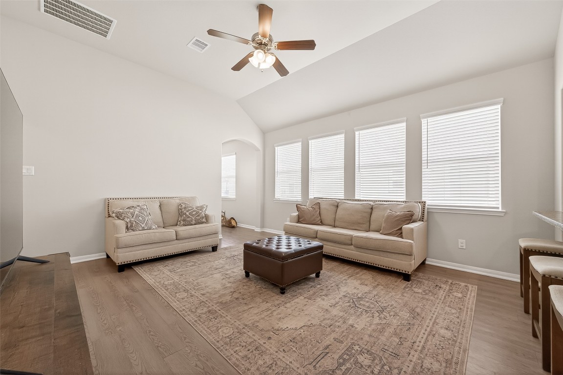 6027 Prince Place Drive Rosenberg, TX 77471 - Photo 8 of 39 A row of windows along the back wall keeps the living room feeling bright, cheerful, and much larger than its footprint.