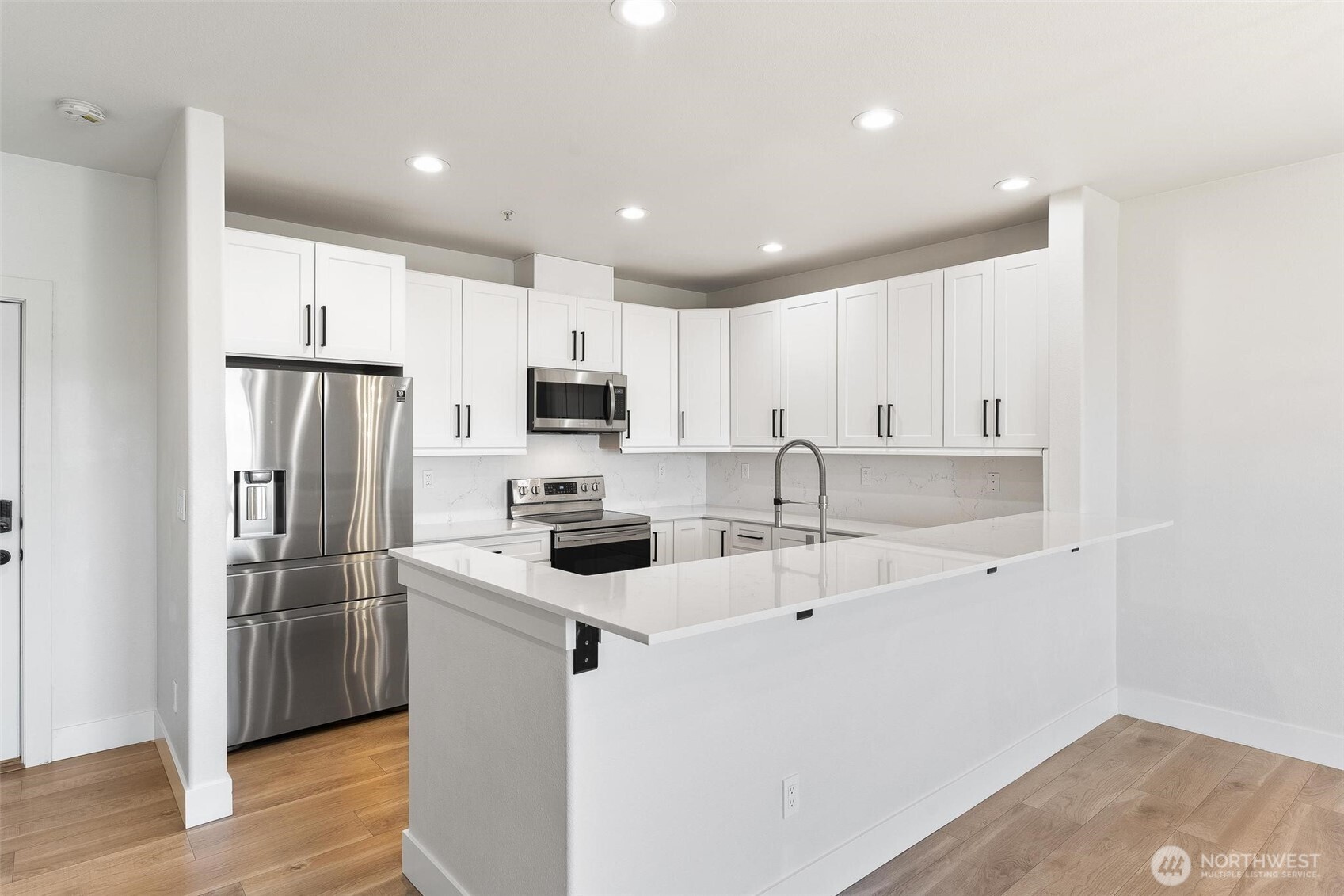 14915 38th Drive Southeast, Unit F3011 Bothell, WA 98012 - Photo 8 of 40 a kitchen with stainless steel appliances a refrigerator sink and microwave