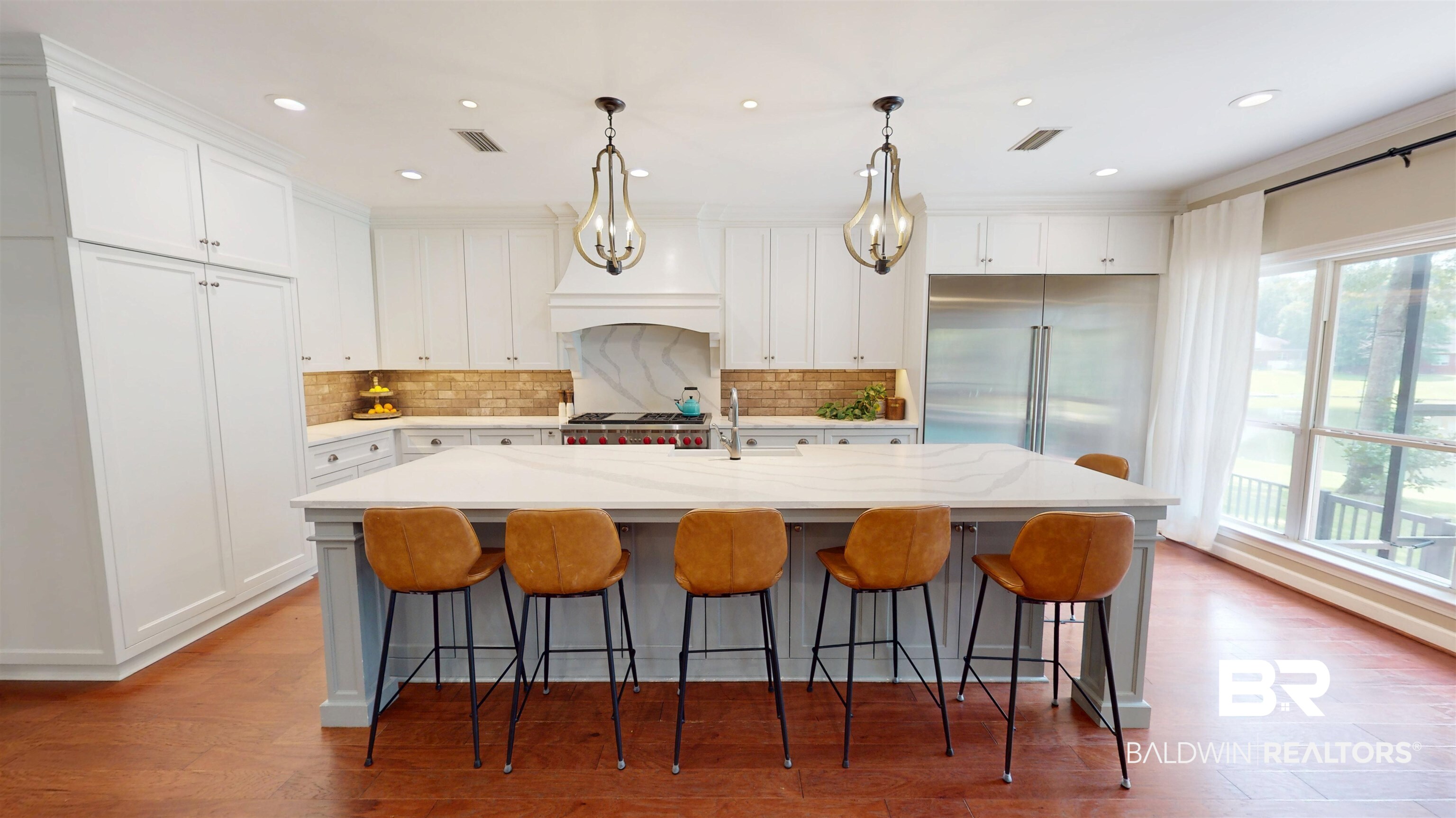 8775 Dawes Lake Road North Mobile, AL 36619 - Photo 9 of 59 Kitchen featuring wood finished floors, decorative backsplash, white cabinetry, a center island with sink, and recessed lighting