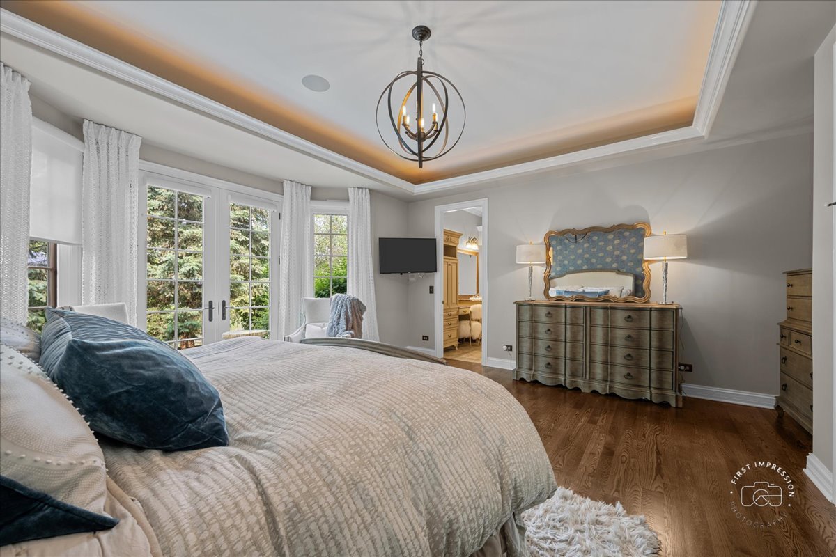 1088 Dunstan Road Geneva, IL 60134 - Photo 18 of 47 a bedroom with a bed and a chandelier