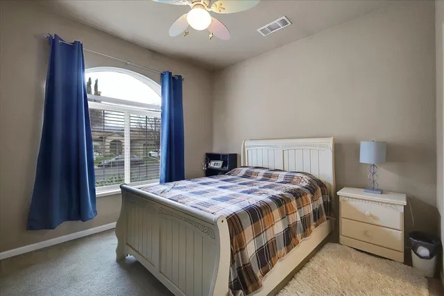 a bedroom with a bed and a large window