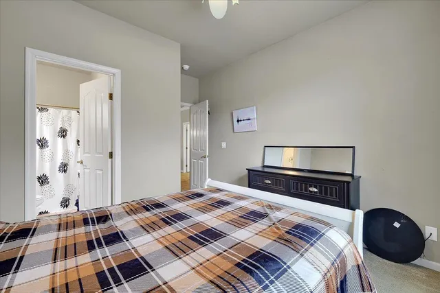 a bedroom with a bed and a dresser