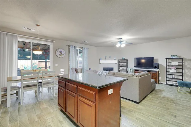 a kitchen with a stove a counter top space and cabinets