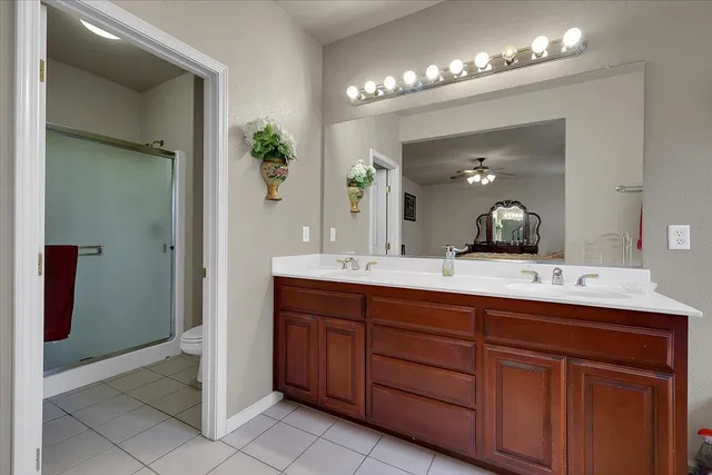 a bathroom with double vanity and a mirror