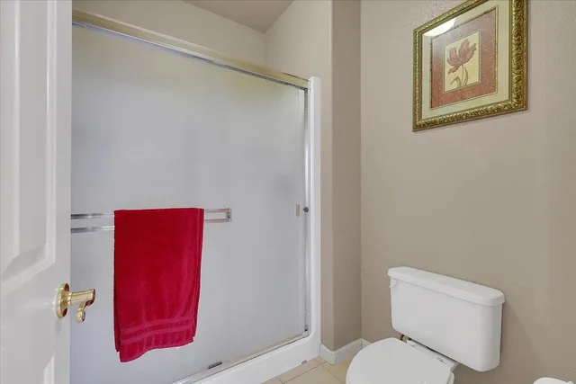 a white toilet sitting next to a bathroom sink