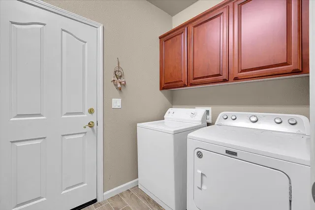 a view of storage and utility room with washer and dryer