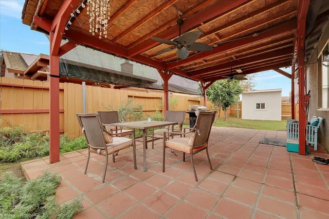 a patio with glass top table and chairs