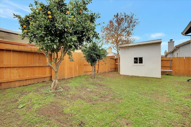 a brick house with a yard and plants