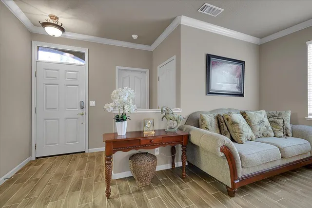 a living room with furniture and wooden floor