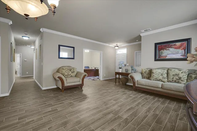 a living room with furniture and a wooden floor