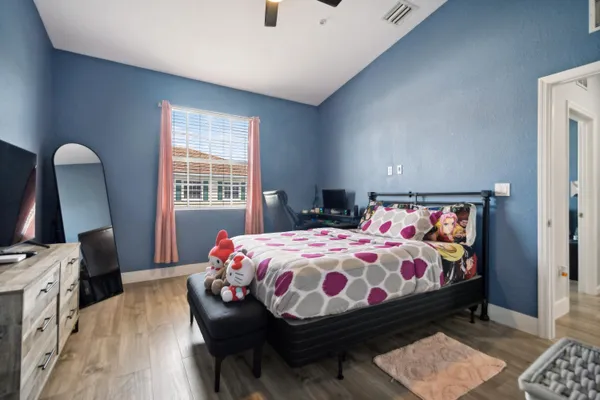 a bedroom with a bed and a dresser in it