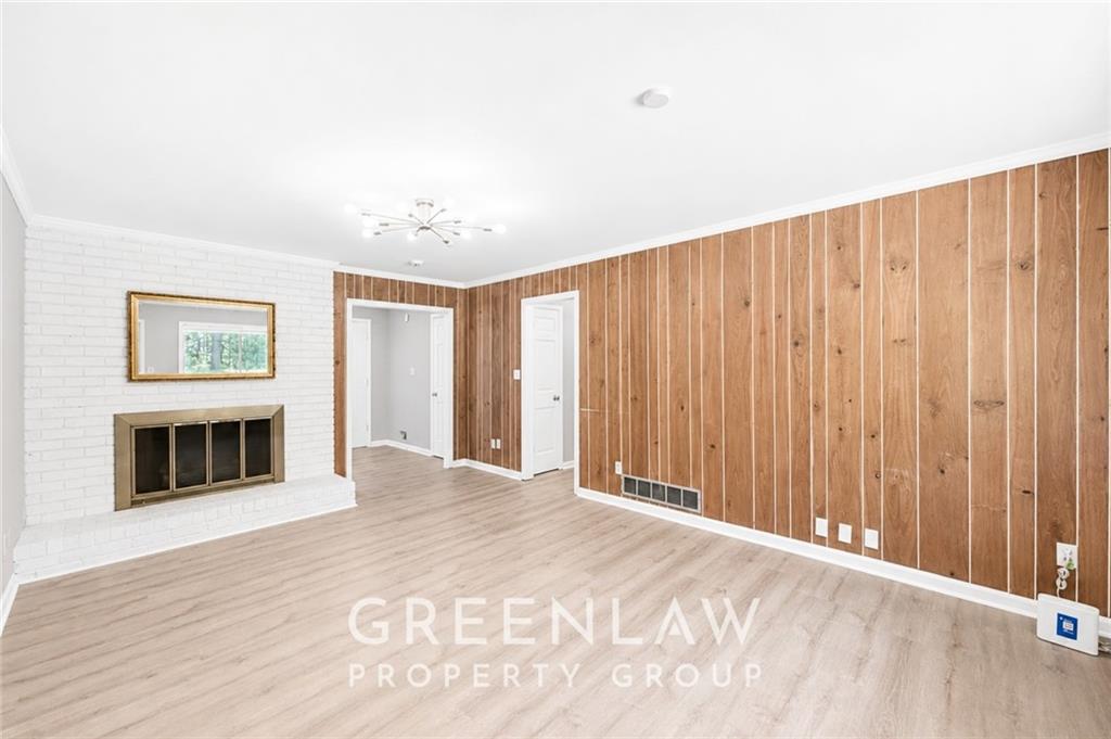 3605 Flat Shoals Road Atlanta, GA 30349 - Photo 10 of 35 a view of a livingroom with wooden floor and a painting on the wall