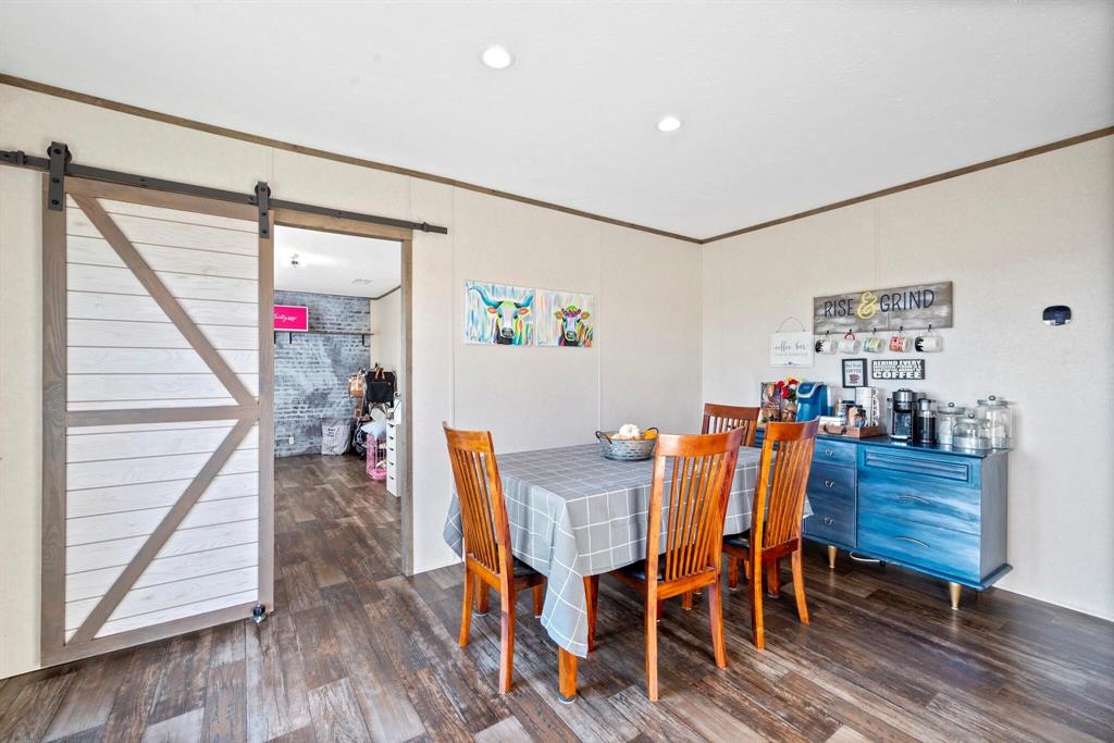 10026 County Rd NW 4350 Frost, TX 76641 - Photo 12 of 33 a view of a dining room with furniture and wooden floor