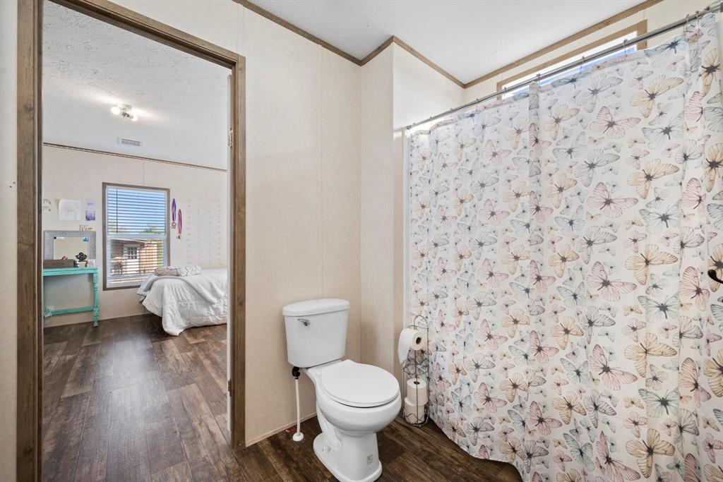 10026 County Rd NW 4350 Frost, TX 76641 - Photo 18 of 32 a white toilet sitting next to a bathroom sink