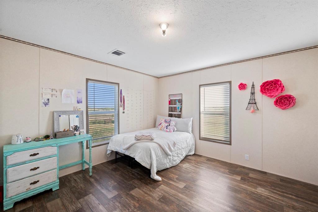 10026 County Rd NW 4350 Frost, TX 76641 - Photo 20 of 32 a bedroom with a bed and a view of bedroom