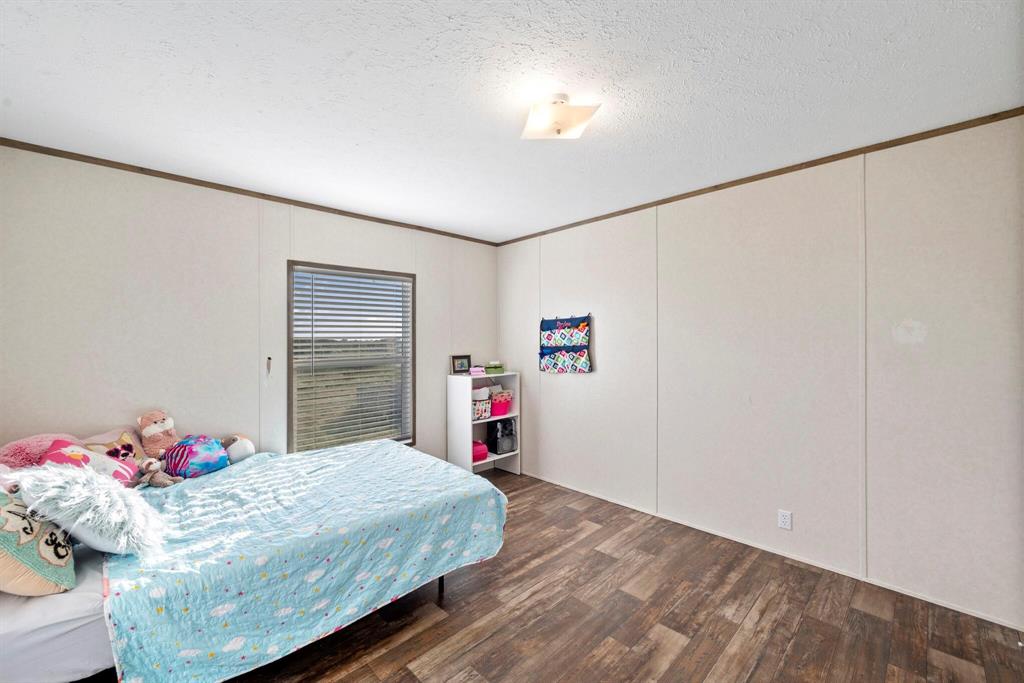 10026 County Rd NW 4350 Frost, TX 76641 - Photo 24 of 33 a bedroom with a bed and a closet