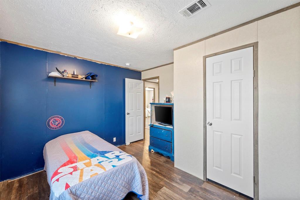 10026 County Rd NW 4350 Frost, TX 76641 - Photo 27 of 33 a bedroom with a bed and a table in it