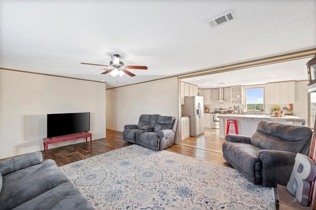 10026 County Rd NW 4350 Frost, TX 76641 - Photo 9 of 32 a living room with furniture and a flat screen tv