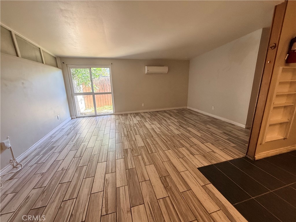 643 West Ramona Drive Rialto, CA 92376 - Photo 4 of 18 a view of empty room with wooden floor and fan