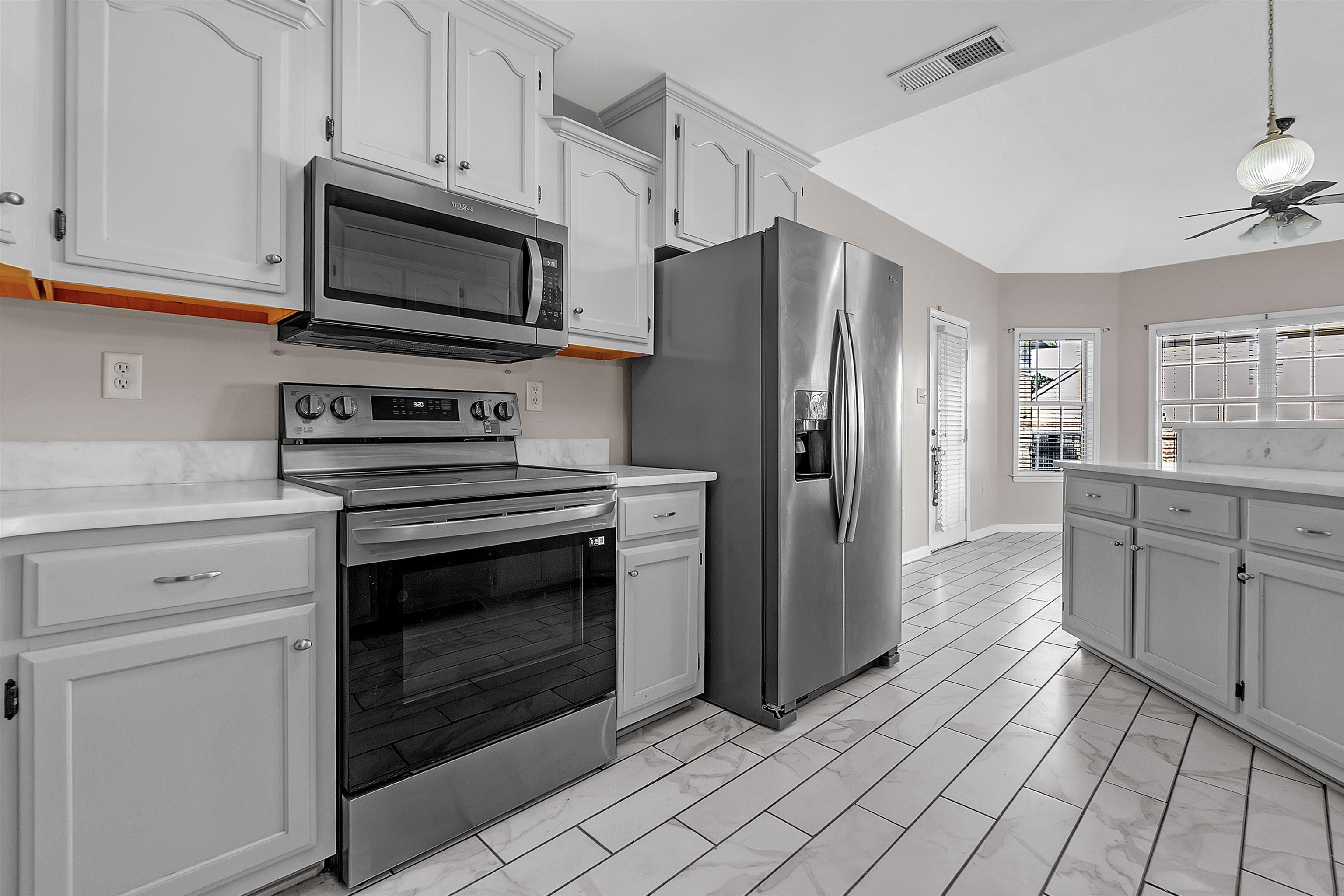 6700 Beagle Lane Bartlett, TN 38002 - Photo 17 of 40 a kitchen with stainless steel appliances granite countertop a refrigerator stove and sink