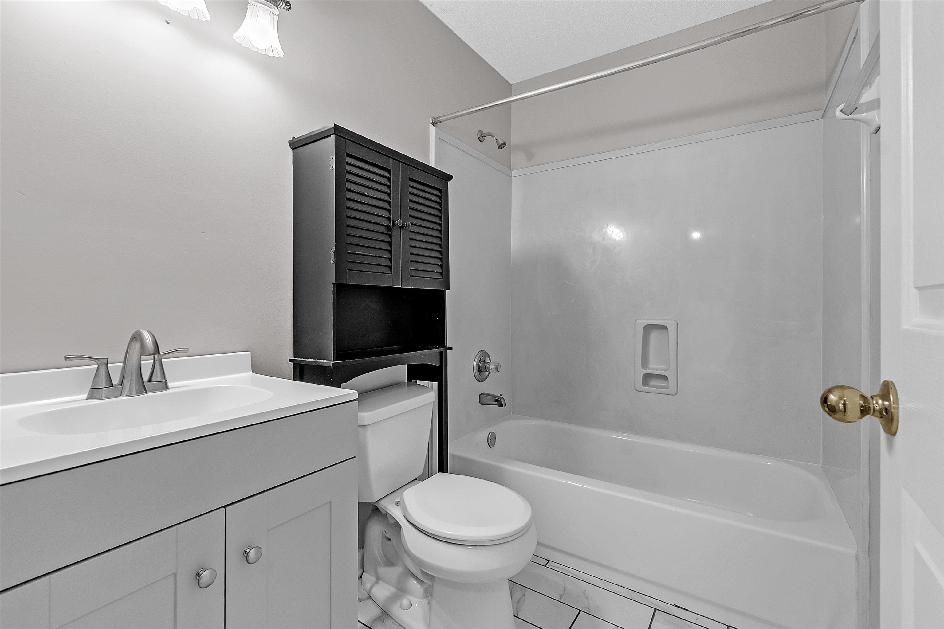 6700 Beagle Lane Bartlett, TN 38002 - Photo 19 of 40 a bathroom with a sink a toilet and a bathtub