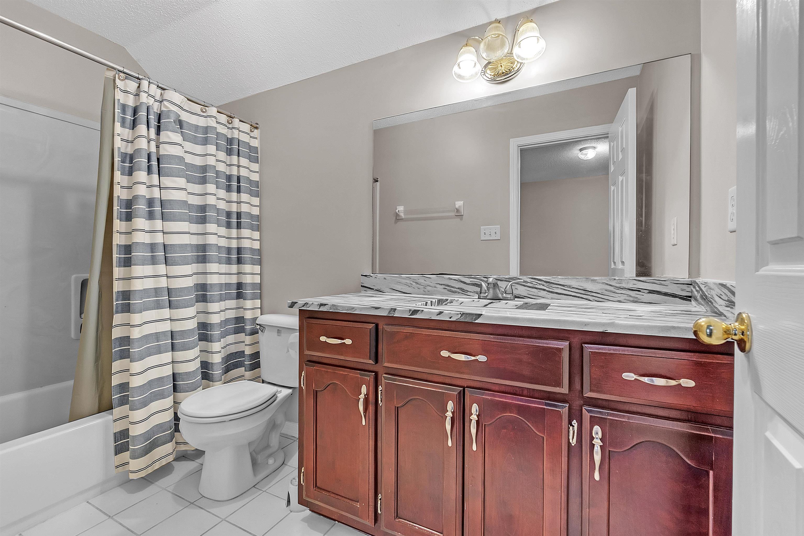 6700 Beagle Lane Bartlett, TN 38002 - Photo 28 of 40 a bathroom with a granite countertop toilet sink and mirror