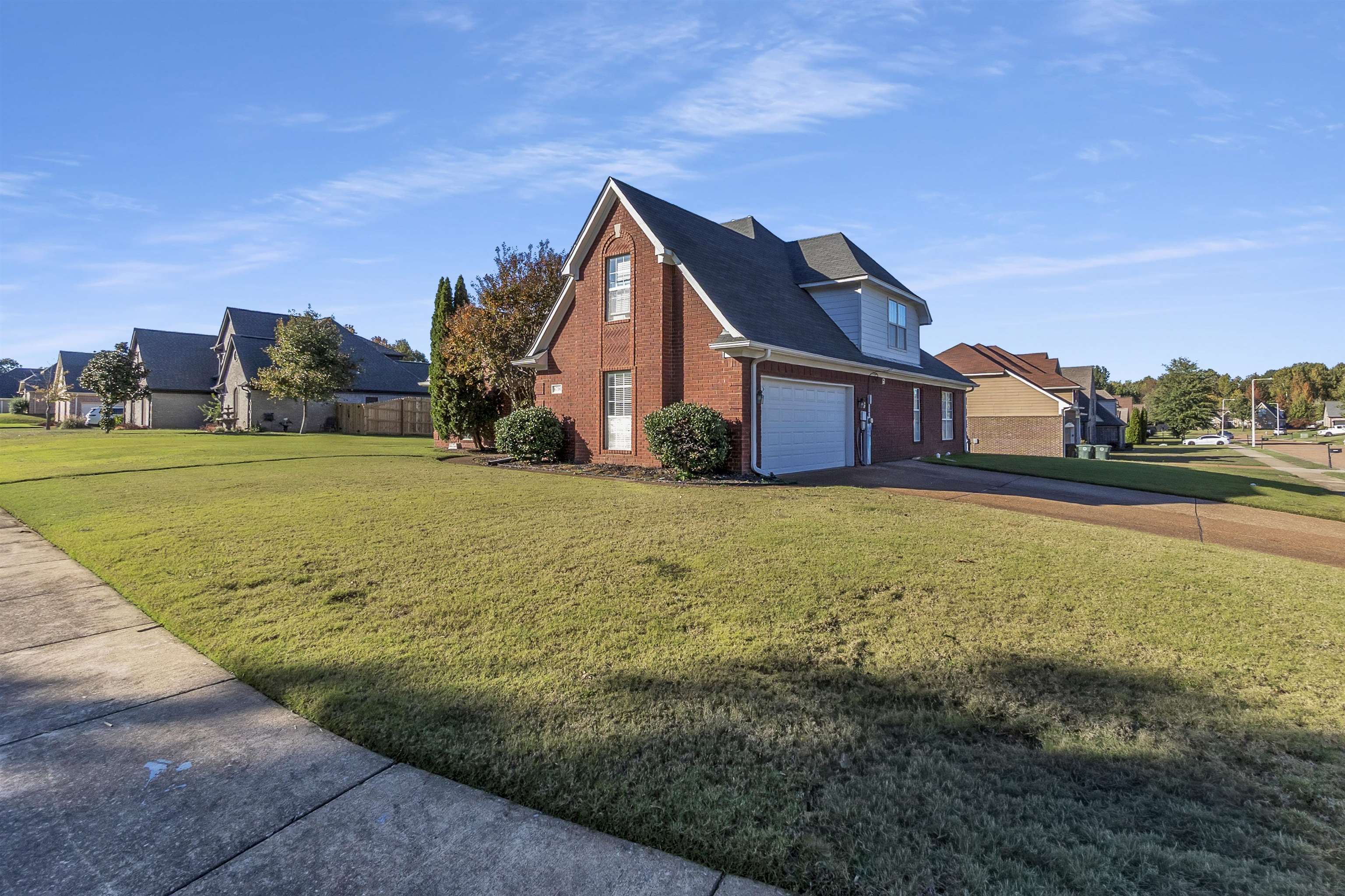 6700 Beagle Lane Bartlett, TN 38002 - Photo 4 of 40 a view of a big house with a big yard and large trees