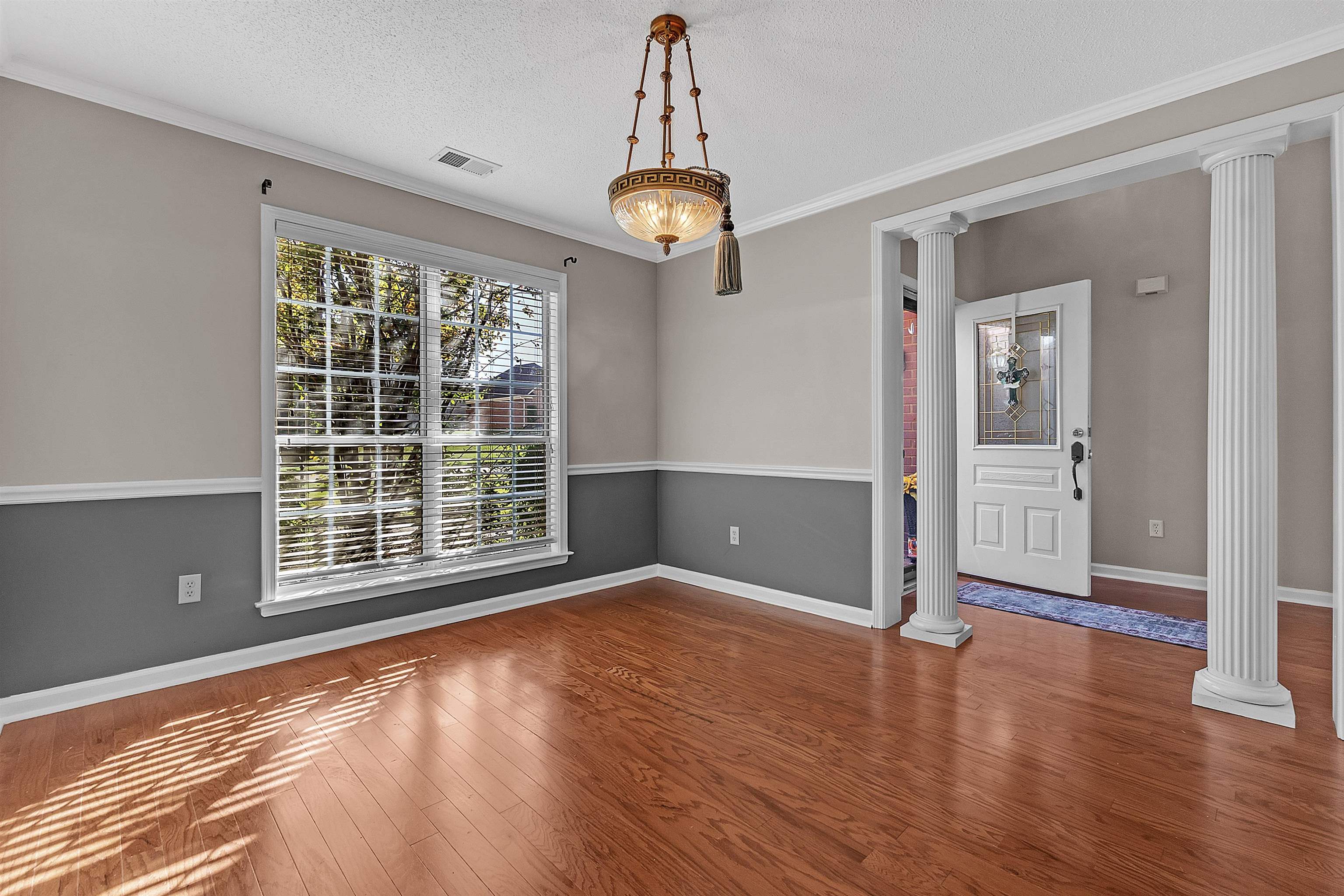 6700 Beagle Lane Bartlett, TN 38002 - Photo 10 of 40 a view of an empty room with wooden floor and a window