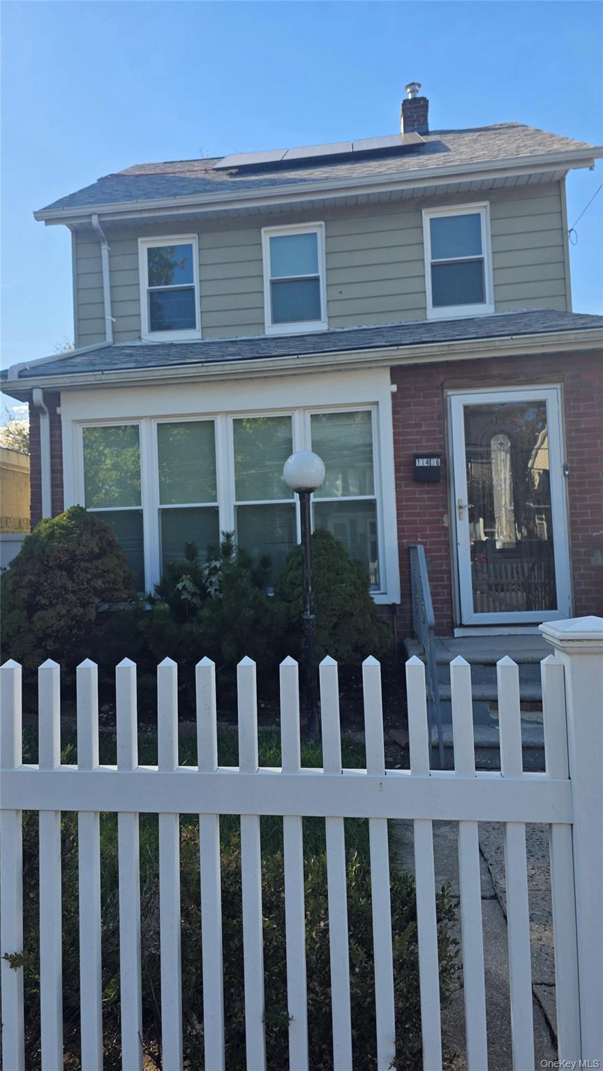 a front view of a house with a small yard