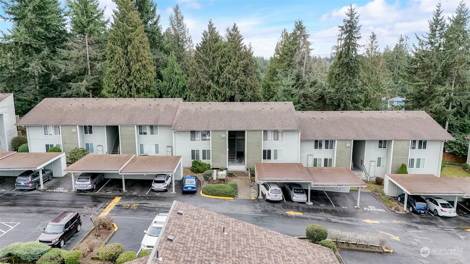 14401 Southeast Petrovitsky Road, Unit D204 Renton, WA 98058 - Photo 24 of 25 a view of a patio with table and chairs under an umbrella