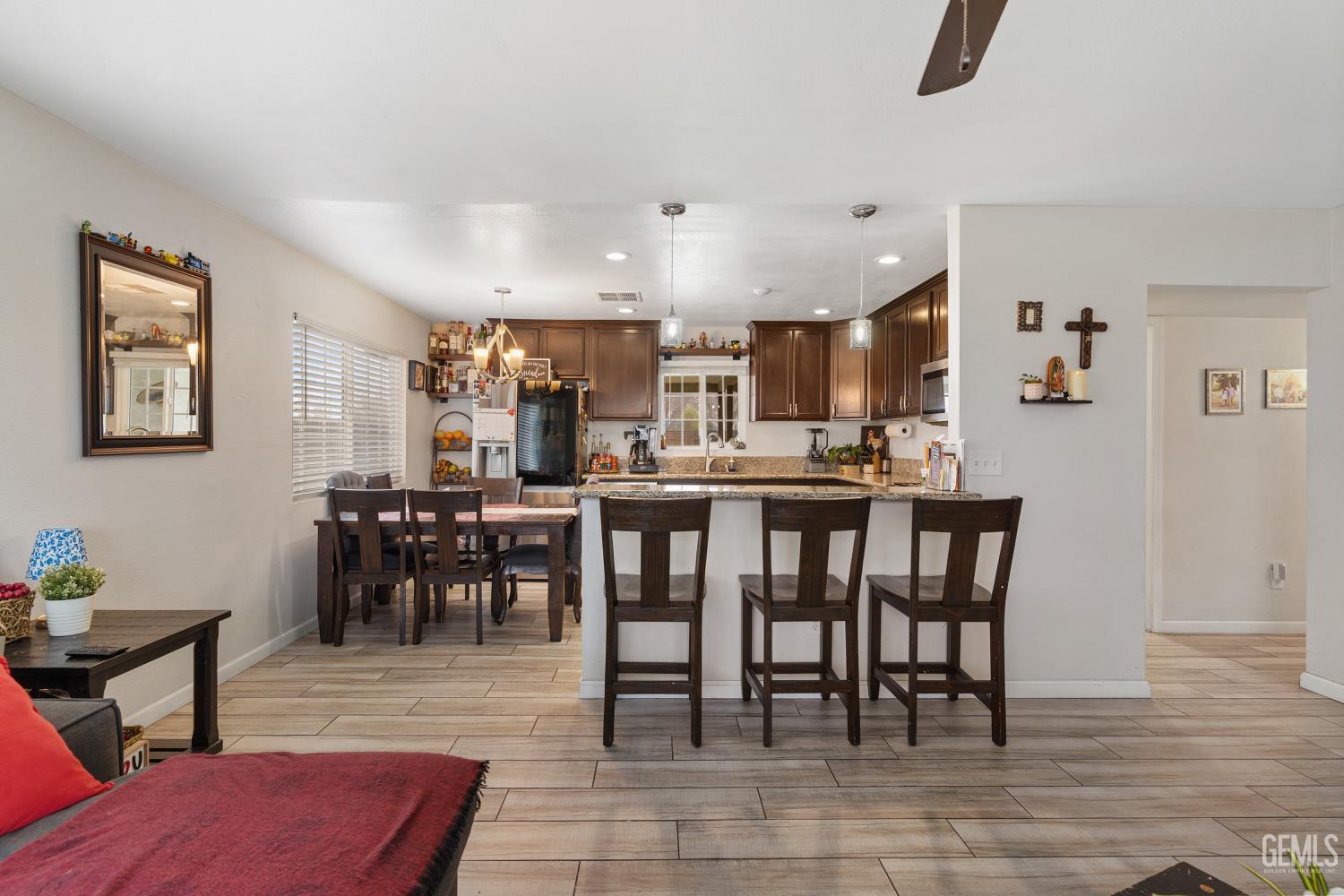 Undisclosed Address Shafter, CA 93263 - Photo 9 of 21 a open kitchen with stainless steel appliances kitchen island granite countertop a dining table chairs and granite counter tops