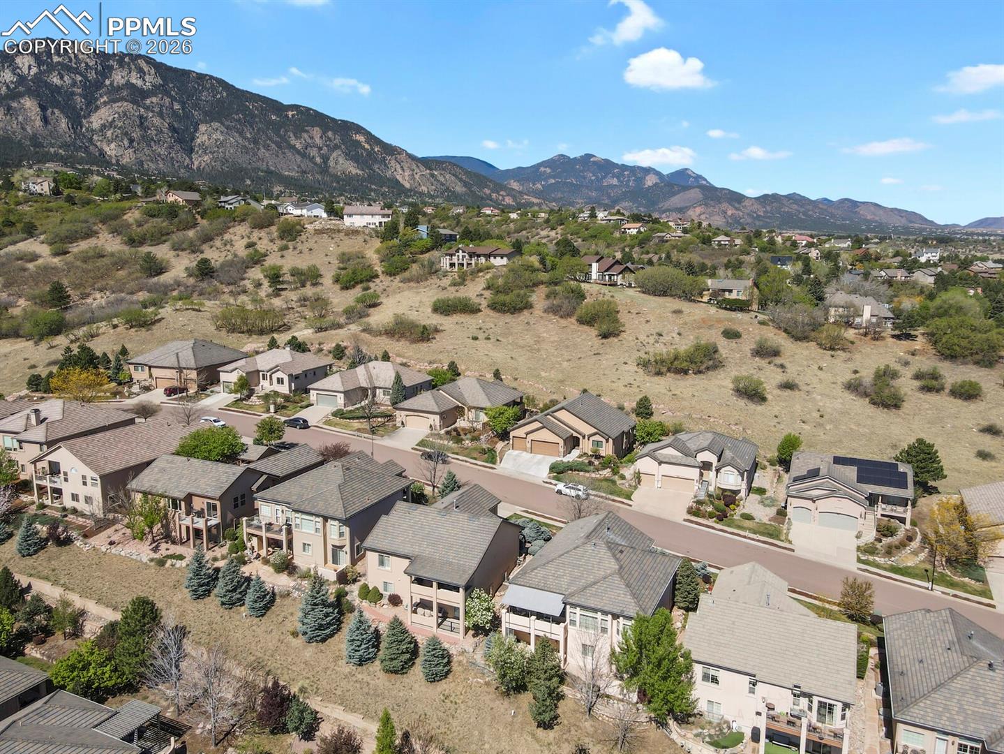 617 Concerto Drive Colorado Springs, CO 80906 - Photo 43 of 46 This aerial view features the property, third home from the bottom right of the photo set against a backdrop of mountainous terrain