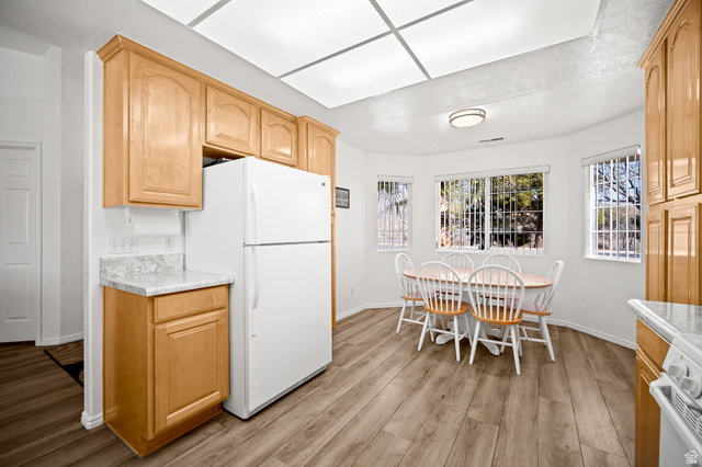 1825 West Mathis Park Place, Unit 46 St. George, UT 84770 - Photo 13 of 45 Kitchen featuring white appliances, light countertops, light wood-style flooring, and light wood finish cabinets