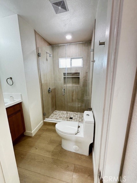 20754 Vose Street Winnetka, CA 91306 - Photo 15 of 32 a bathroom with a sink a toilet and shower