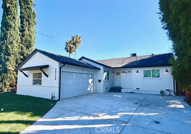 20754 Vose Street Winnetka, CA 91306 - Photo 2 of 21 a view of a house with a yard and a garage