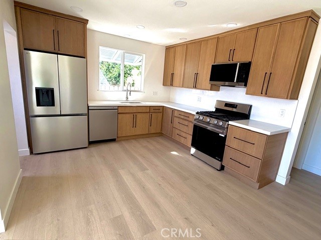 20754 Vose Street Winnetka, CA 91306 - Photo 5 of 32 a kitchen with a refrigerator stove and microwave