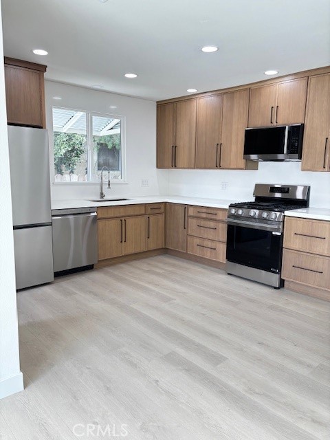 20754 Vose Street Winnetka, CA 91306 - Photo 8 of 32 a kitchen with stainless steel appliances granite countertop a stove a sink and a microwave