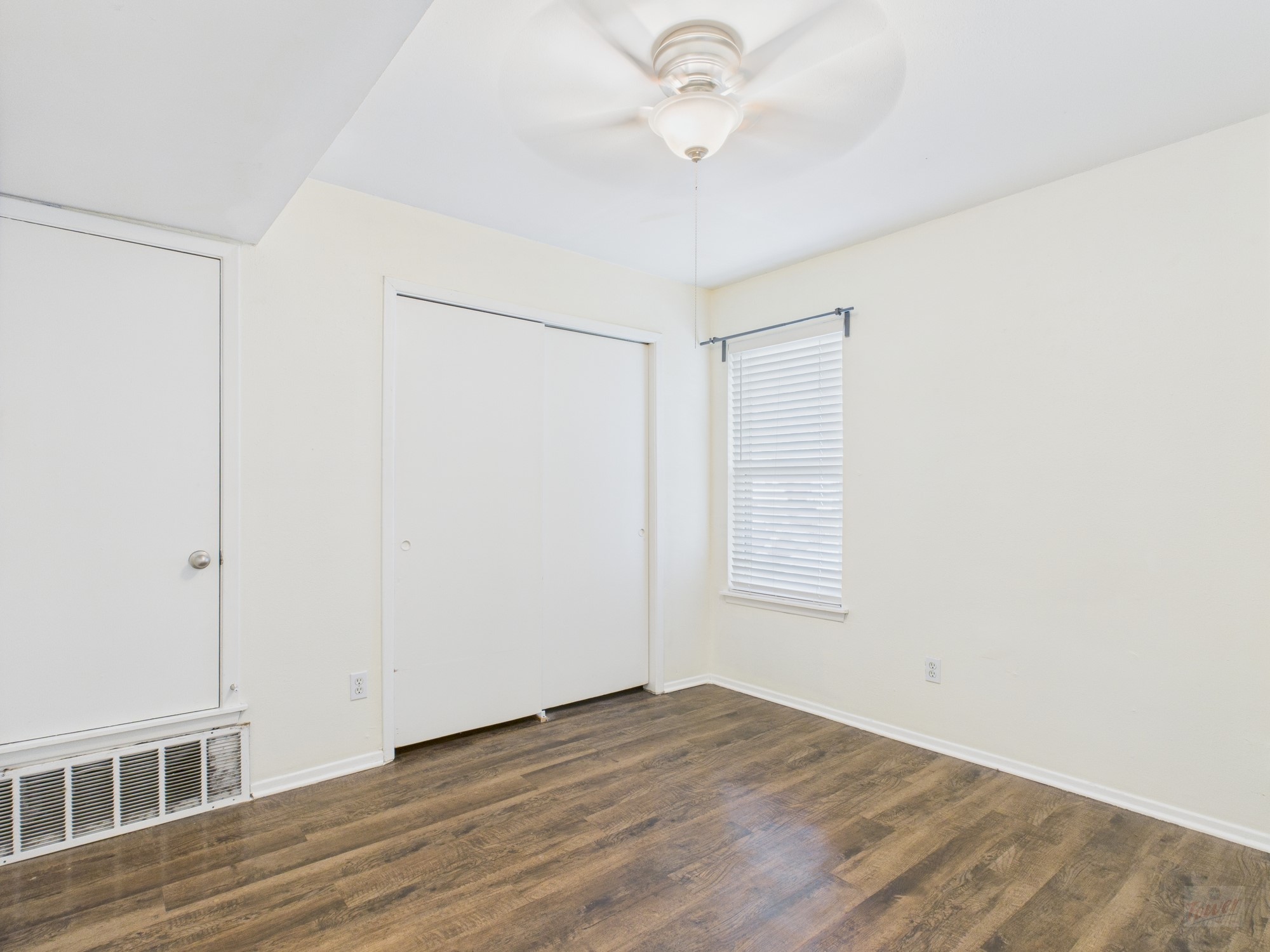 1106 West 22nd Street, Unit 5 Austin, TX 78705 - Photo 12 of 13 a view of an empty room with wooden floor and a window